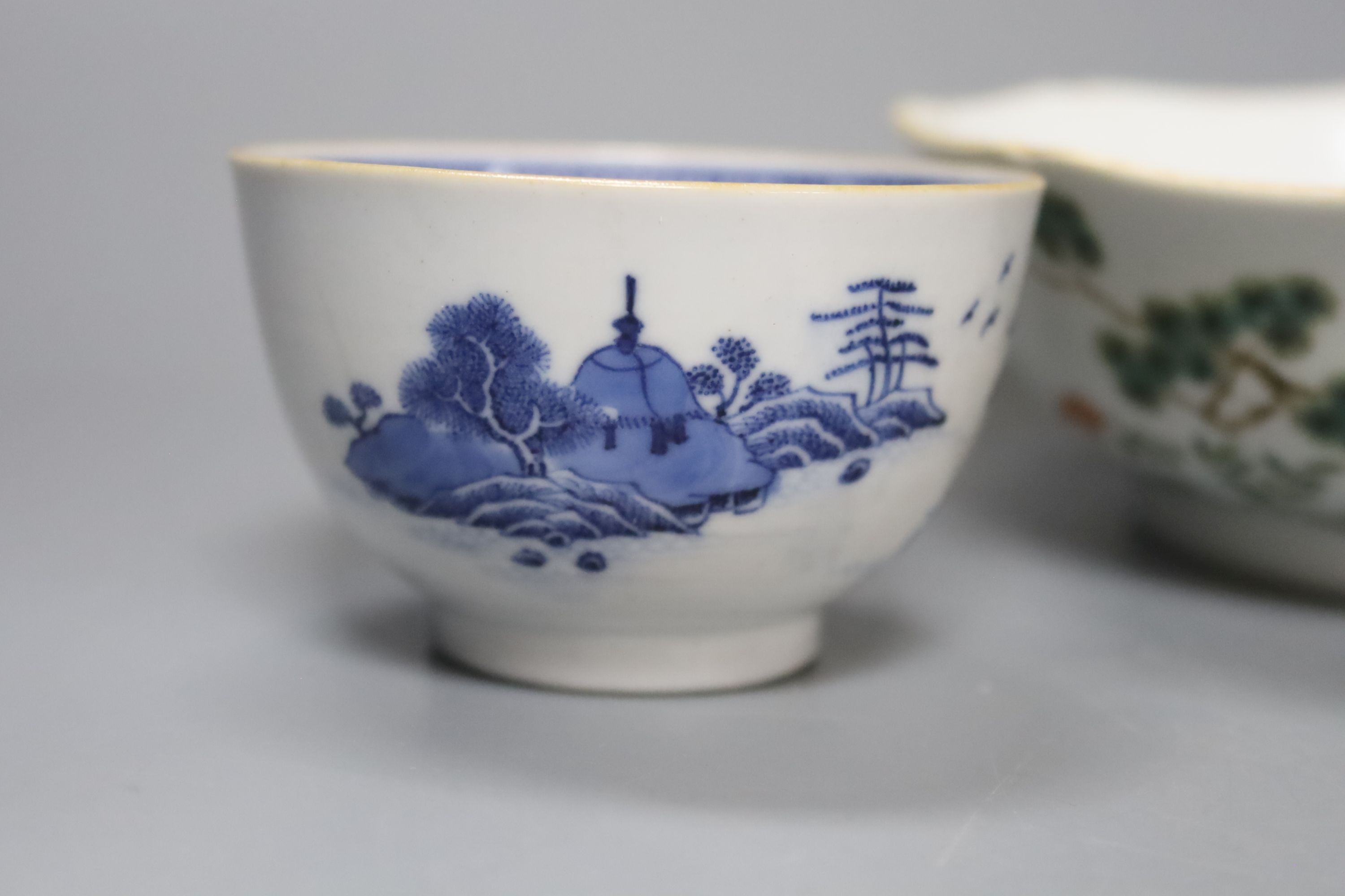 Two Chinese famille rose bowls together with a similar blue and white bowl, largest diameter 14cm